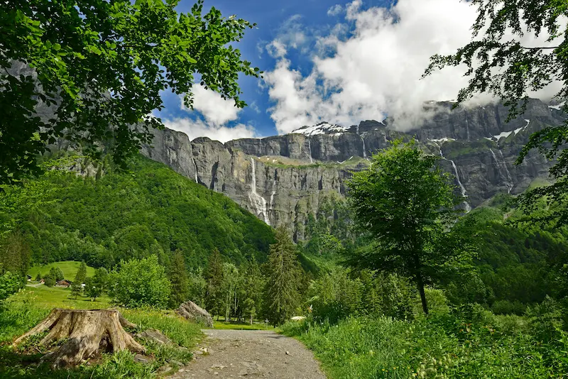Alpine cliffs, waterfalls and green valley path in Haute-Savoie mountains, France digital detox retreat destination in the Alps