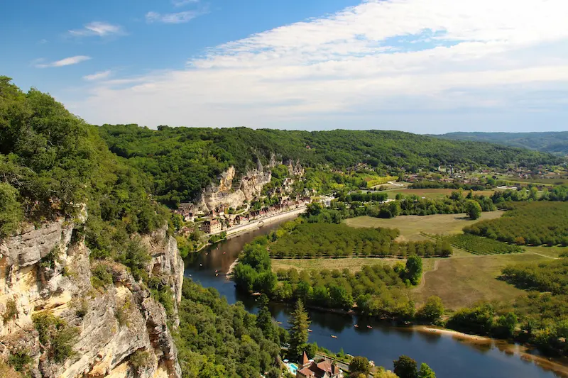Aerial view of Dordogne river, cliffside village and green countryside in Périgord, France digital detox retreat destination